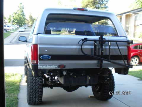 1996 Ford Bronco - Rear view of a lifted 1996 Ford Bronco showing the spare tire carrier and Rough Country branding.