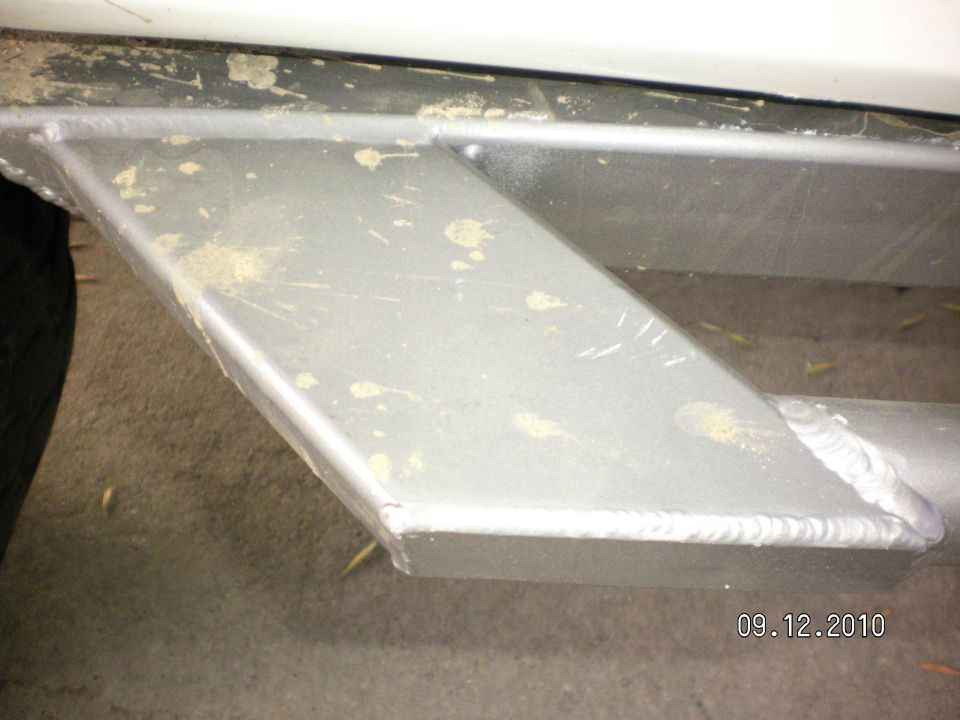 Aftermarket rock sliders with visible welds and mud splatter