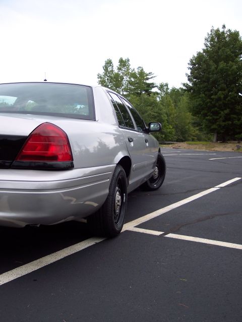 2001 Ford Crown Victoria - Rear view of a silver 2001 Ford Crown Victoria police car with blacked-out trunk.