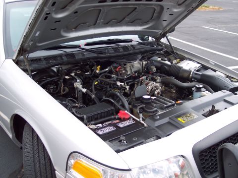 2001 Ford Crown Victoria - The engine compartment of a 2001 Ford Crown Victoria is shown with the hood open.