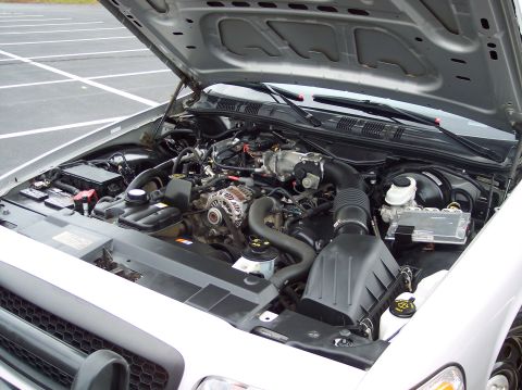 2001 Ford Crown Victoria - Engine bay of a 2001 Ford Crown Victoria, viewed from the front with the hood raised.