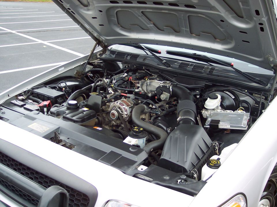 2001 Ford Crown Victoria engine bay with hood open, showing engine components and battery