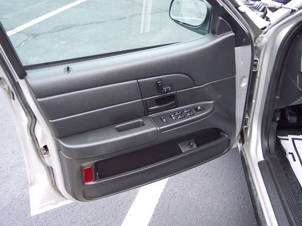 Driver's side door panel with window and lock controls visible