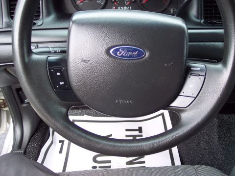 2001 Ford Crown Victoria - Interior view of a Ford vehicle, showing the steering wheel, dashboard, and instrument cluster.