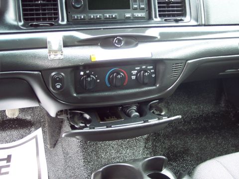 2001 Ford Crown Victoria - Interior view of a police vehicle's dashboard, showing climate controls and a storage bin.