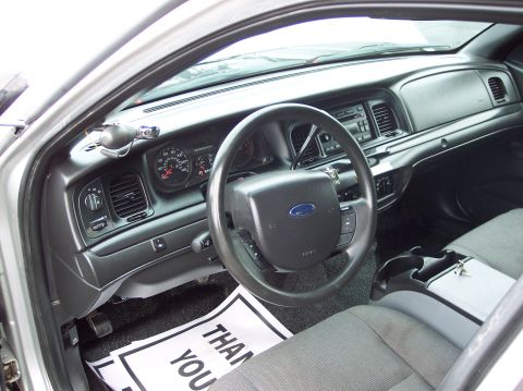 2001 Ford Crown Victoria - Interior view of a 2001 Ford Crown Victoria, the dashboard, steering wheel, and passenger seat.