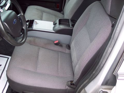 2001 Ford Crown Victoria - Interior view of a 2001 Ford Crown Victoria police car, highlighting the front seating area and console.