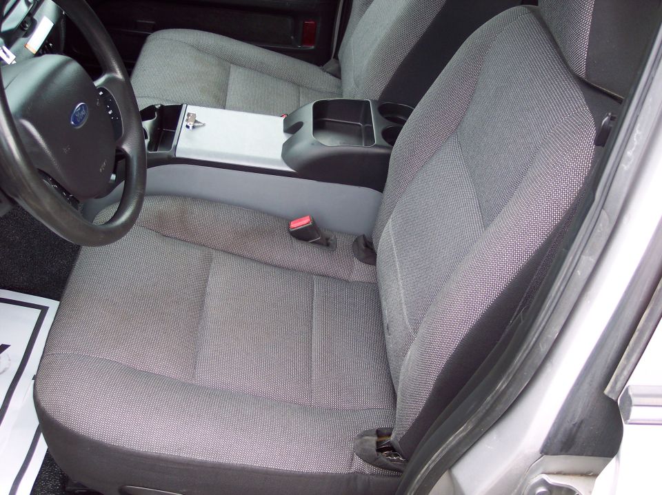 2001 Ford Crown Victoria police car interior showing front seats, steering wheel, and center console
