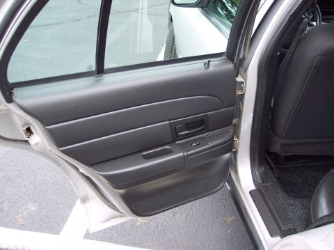 2001 Ford Crown Victoria - Interior view of a 2001 Ford Crown Victoria, showing the door panel and rear seating area.