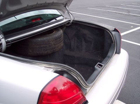 2001 Ford Crown Victoria - The trunk of a 2001 Ford Crown Victoria is open, revealing a spare tire and the interior.