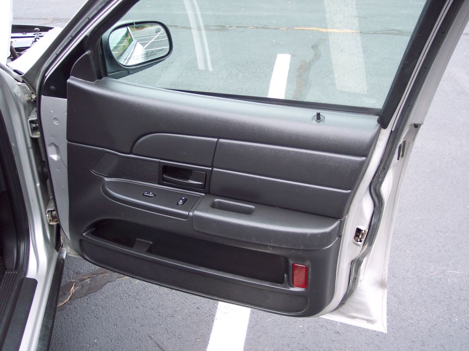 2001 Ford Crown Victoria interior door panel with window controls and storage pocket