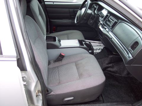 2001 Ford Crown Victoria - Interior view of a 2001 Ford Crown Victoria, showing the front seats and dashboard.