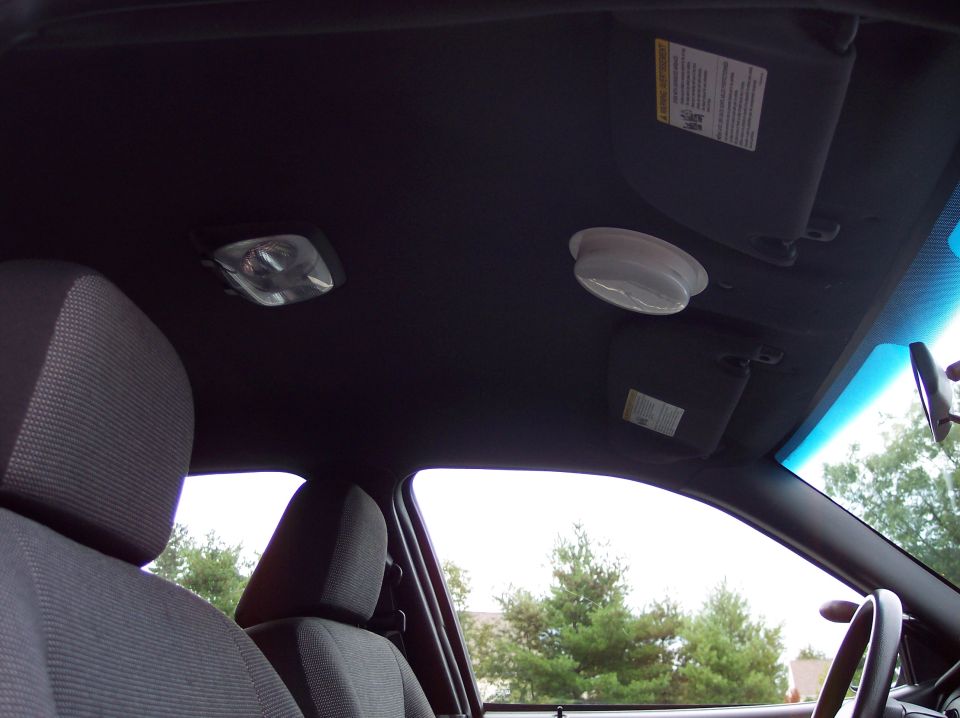 Interior view of a 2001 Ford Crown Victoria police car, showing headliner, sun visors, and dome light