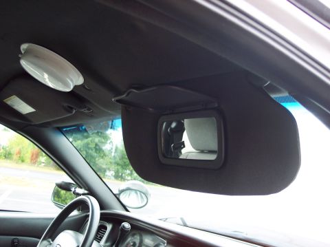 2001 Ford Crown Victoria - The interior of a vehicle, focusing on the sun visors and a portion of the dashboard.