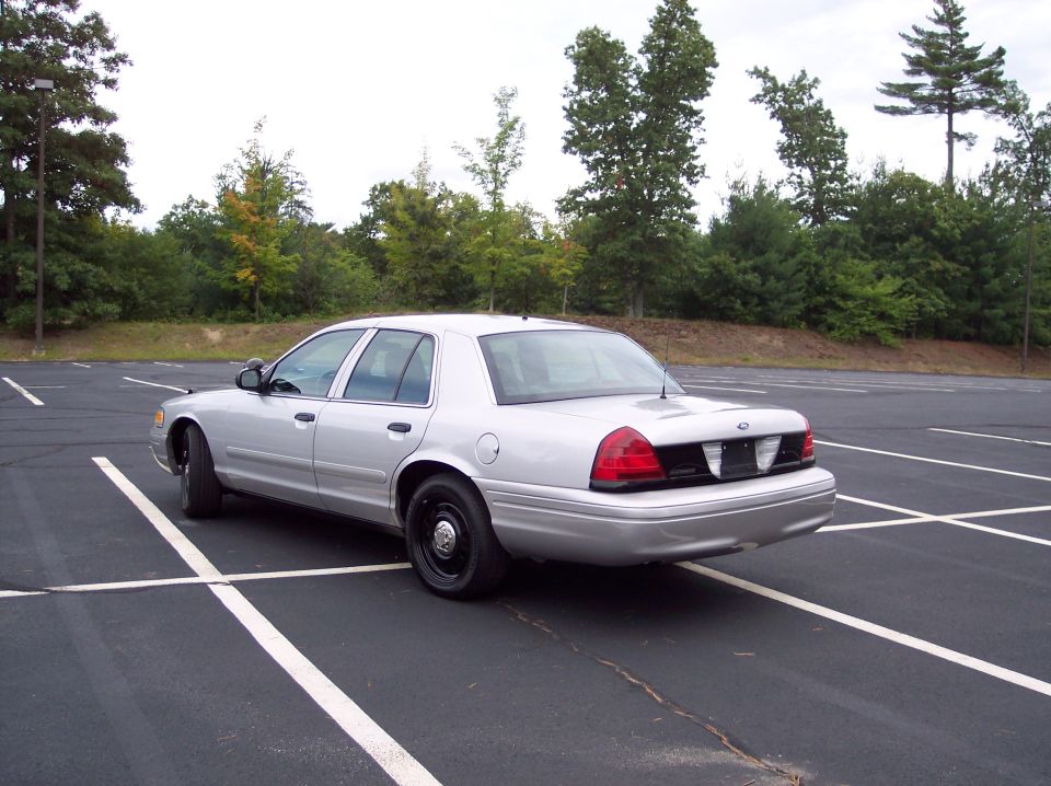 Silver 2001 Ford Crown Victoria parked in a lot, rear 3/4 view