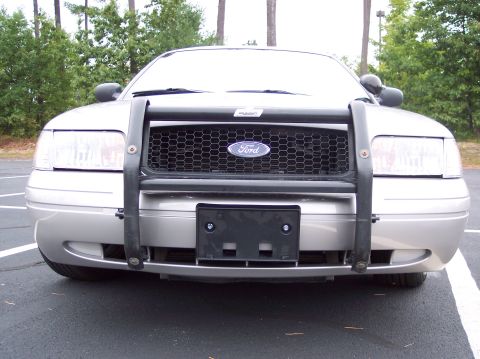 2001 Ford Crown Victoria - Front view of a silver 2001 Ford Crown Victoria police car with a push bar.