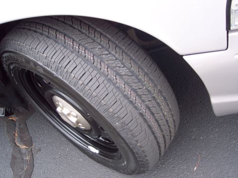 2001 Ford Crown Victoria - Close-up of the wheel and tire on a silver 2001 Ford Crown Victoria.