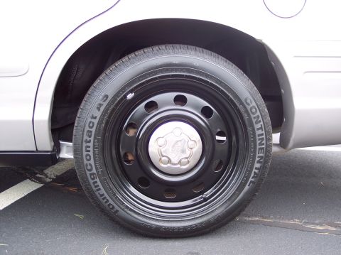 2001 Ford Crown Victoria - Close-up of a 2001 Ford Crown Victoria's steel wheel and tire.