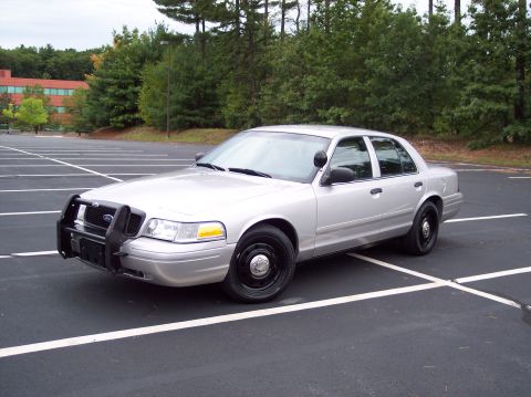 2001 Ford Crown Victoria - This 2001 Ford Crown Victoria, equipped with a push bumper, is seen from a three-quarter front view in a parking lot.