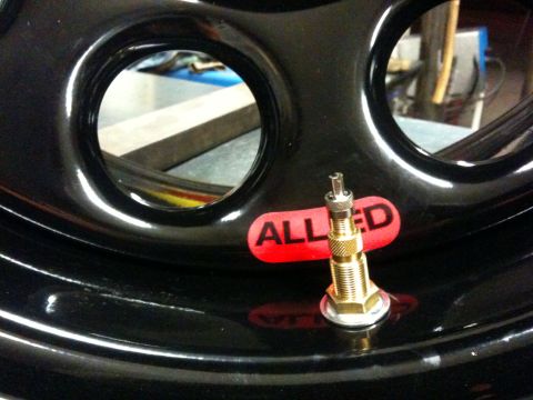Suzuki Samurai - This photo shows a wheel part with an Allied sticker and a valve stem, not a 2009 Suzuki Samurai.