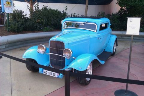 1991 Ford LTD Crown Victoria - This blue 1932 Ford hot rod coupe is on display with a sign and velvet ropes.