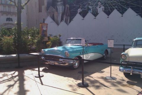1991 Ford LTD Crown Victoria - A vintage teal and white convertible is displayed next to another vehicle.