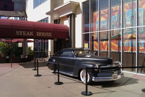 1991 Ford LTD Crown Victoria - Classic 1946 Ford coupe parked in front of a steak house, likely a display piece.