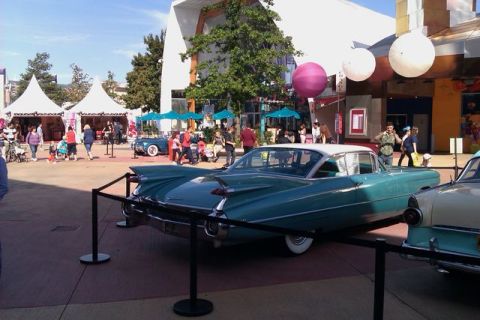 1991 Ford LTD Crown Victoria - A classic teal and white Cadillac is displayed outdoors with tents and people in the background.