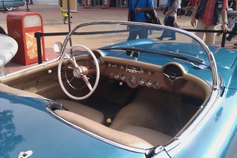 1991 Ford LTD Crown Victoria - The interior of a classic blue convertible shows a tan dashboard with numerous gauges and a white steering wheel.