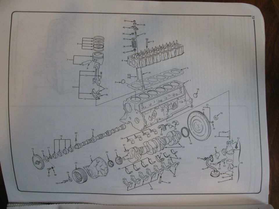 Exploded parts drawing of inline engine block, crankshaft, pistons and timing components
