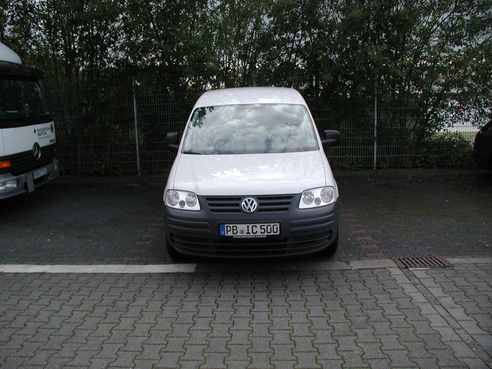 White Volkswagen Caddy van parked, license plate PB IC 500