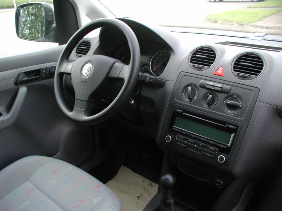 VW interior showing steering wheel, dashboard vents, radio, and manual shifter
