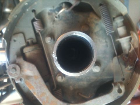 1966 Ford Bronco - Close-up view of a vehicle's brake drum assembly, showing internal components like brake shoes and springs.