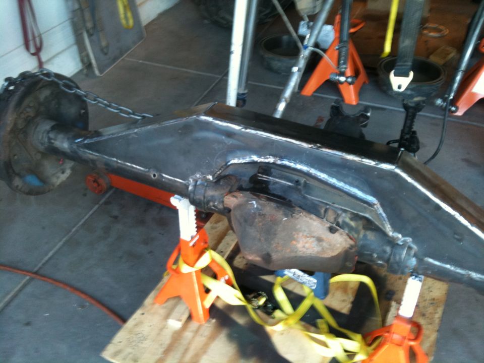 Vehicle axle assembly on jack stands, with chain attached to differential