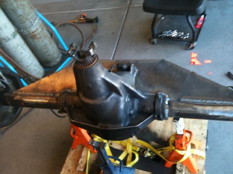 1966 Ford Bronco - A rear axle assembly is shown supported by orange jack stands in a workshop setting.