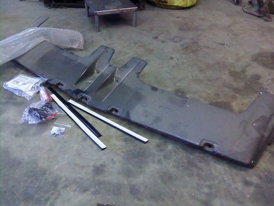 Gray Ford Bronco front bumper cover with trim pieces and hardware