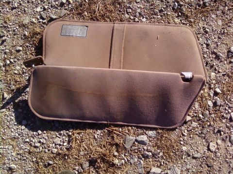 1995 Ford Bronco - A sun visor is shown lying on the ground, detached from any vehicle.