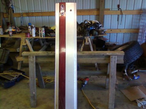 1995 Ford Bronco - A vertical panel with a Ford emblem and a red stripe is displayed in a workshop setting.