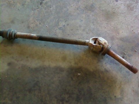1995 Ford Bronco - Rusty driveshaft part with a U-joint, likely for a vehicle.