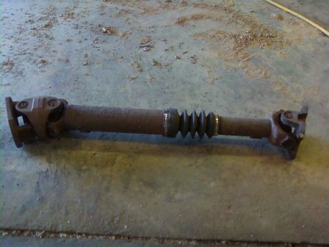 1995 Ford Bronco - A used driveshaft is shown on a concrete surface, with a Supermotors.net watermark in the corner.