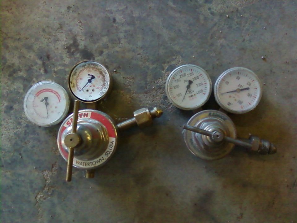 Two pressure regulators with gauges, one labeled Smith Watertown SD USA
