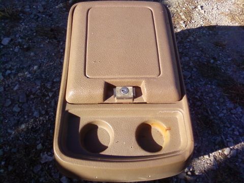 1995 Ford Bronco - Center console part with cup holders and a lockable lid, likely from an older SUV.