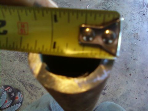 1995 Ford Bronco - A tape measure is used to measure a metal pipe, with the Supermotors.net logo visible in the lower right corner.