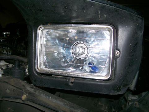 1995 Ford Probe - Close-up of a vehicle's headlight assembly, showing the clear lens and internal components.