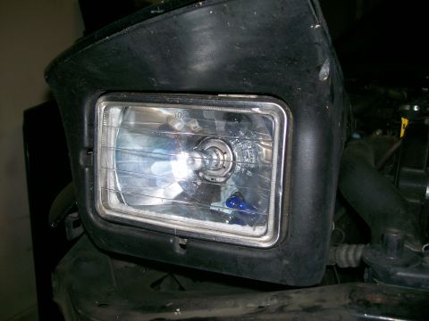 1995 Ford Probe - Close-up view of a vehicle's headlight assembly, showing the bulb and surrounding trim.