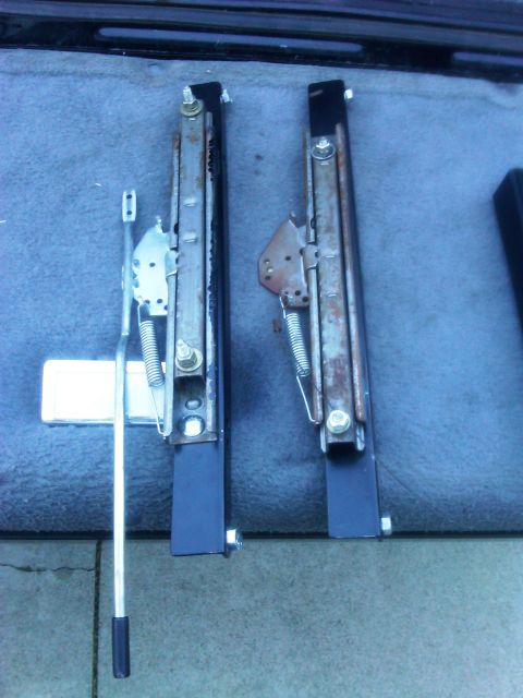 1986 Ford Bronco - Pair of car seat sliders, likely for a Ford Bronco, shown removed from the vehicle.