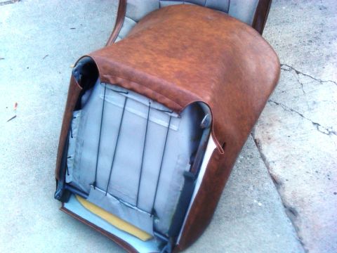 1986 Ford Bronco - This image shows the internal structure of a car seat, with the brown vinyl upholstery removed to reveal the springs and padding beneath.