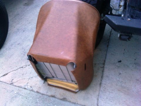 1986 Ford Bronco - Car seat with brown vinyl upholstery and visible foam and metal frame.