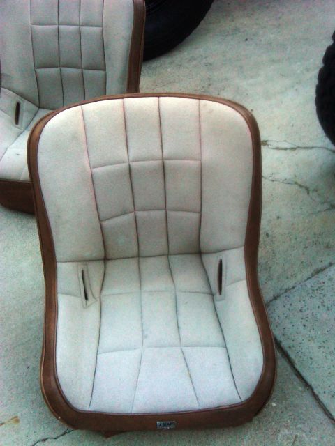 1986 Ford Bronco - Close-up of two vintage car seats, possibly for a truck or SUV, with a quilted pattern on light fabric.