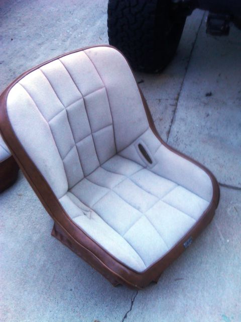 1986 Ford Bronco - A single car seat with a quilted pattern is shown, with a portion of a tire visible in the background.